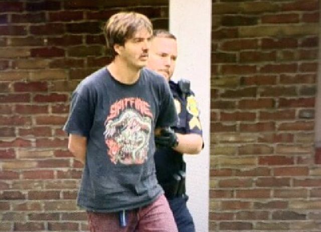 Previous photo: Robert Boyd is led away in handcuffs by Boardman Police