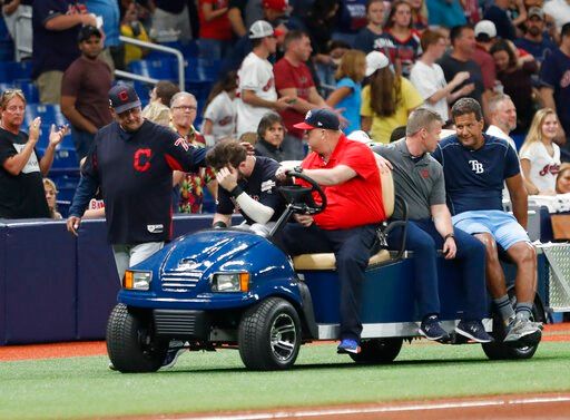 Cleveland Indians manager Terry Francona, left, walks with left fielder Tyler Naquin who is carted off the field against the Tampa Bay Rays during the fifth inning of a baseball game Friday, Aug. 30, 2019, in St. Petersburg, Fla. (AP Photo/Scott Audette)