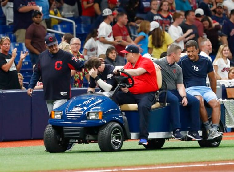 Cleveland Indians manager Terry Francona, left, walks with left fielder Tyler Naquin who is carted off the field against the Tampa Bay Rays during the fifth inning of a baseball game Friday, Aug. 30, 2019, in St. Petersburg, Fla. (AP Photo/Scott Audette)