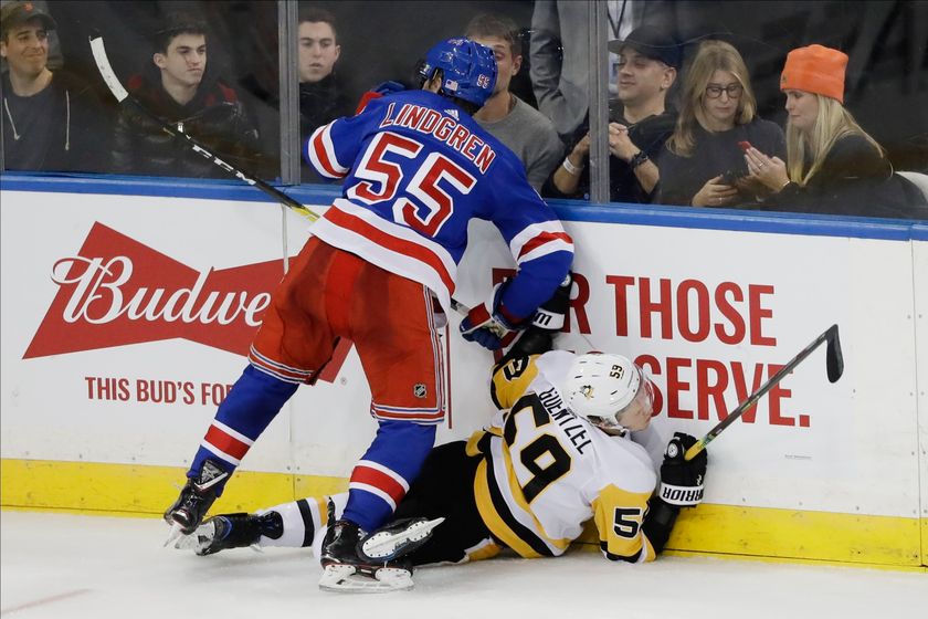 New York Rangers' Ryan Lindgren (55) checks Pittsburgh Penguins' Jake Guentzel (59) during the third period of an NHL hockey game Tuesday, Nov. 12, 2019, in New York. The Rangers won 3-2.