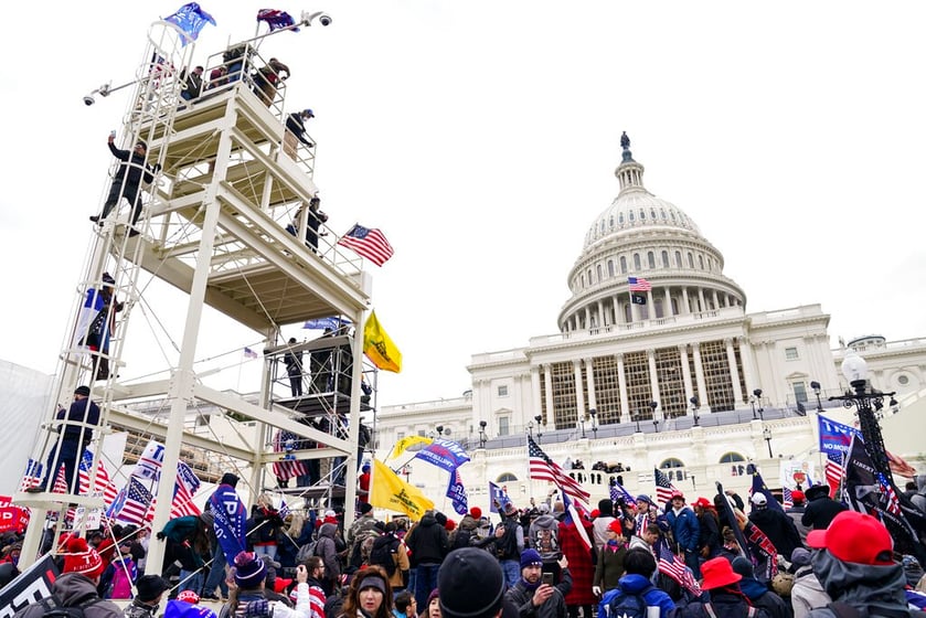 Supporters loyal to President Donald Trump clash with authorities before successfully breaching the Capitol building during a riot on the grounds, Wednesday, Jan. 6, 2021.