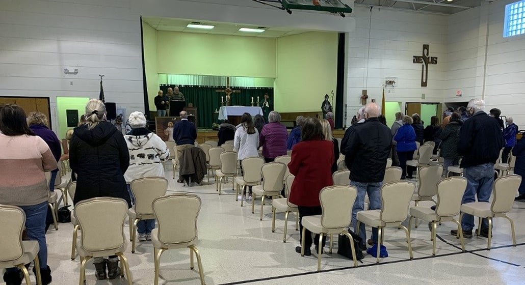 Parishioners gather for Mass at the social hall