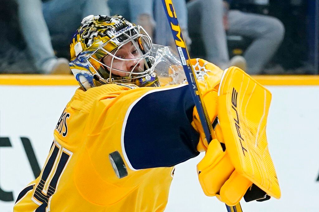 Nashville Predators goaltender Juuse Saros blocks a shot against the Pittsburgh Penguins in the second period of an NHL hockey game Tuesday, March 15, 2022, in Nashville, Tenn.