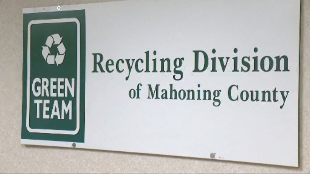 Green Team holding scrap tire, household electronic recycling events