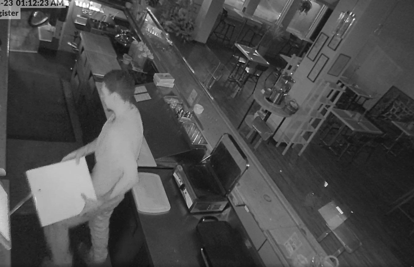 Security camera footage captures suspect stealing cash register at