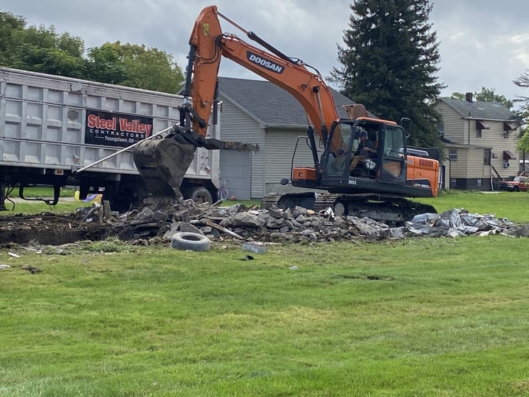 Crew members work to tear down vacant homes on Penhale Avenue in Campbell