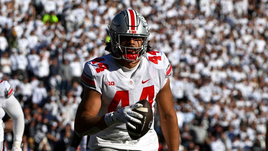 Ohio State defensive end J.T. Tuimoloau (44) returns an interception for a touchdown against Penn State during an NCAA college football game, Saturday, Oct. 29, 2022, in State College, Pa.