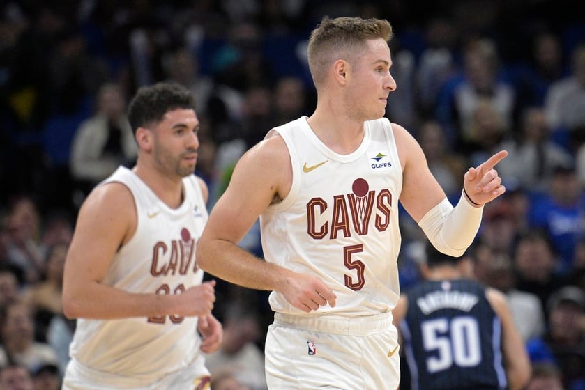 Cleveland Cavaliers guard Sam Merrill (5) reacts after scoring a 3-point basket as forward Georges Niang, left, watches during the first half of an NBA basketball game against the Orlando Magic, Monday, Jan. 22, 2024, in Orlando, Fla.