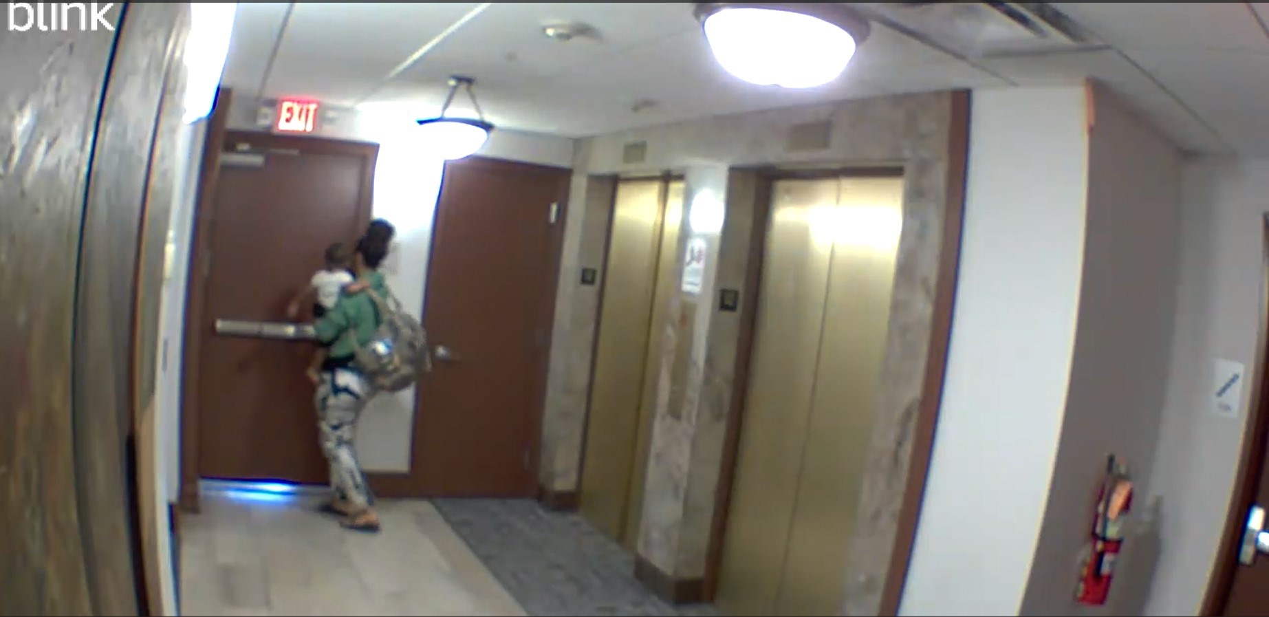 A woman narrowly escapes the building with her baby