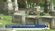 Volunteers place flags for fallen heroes
