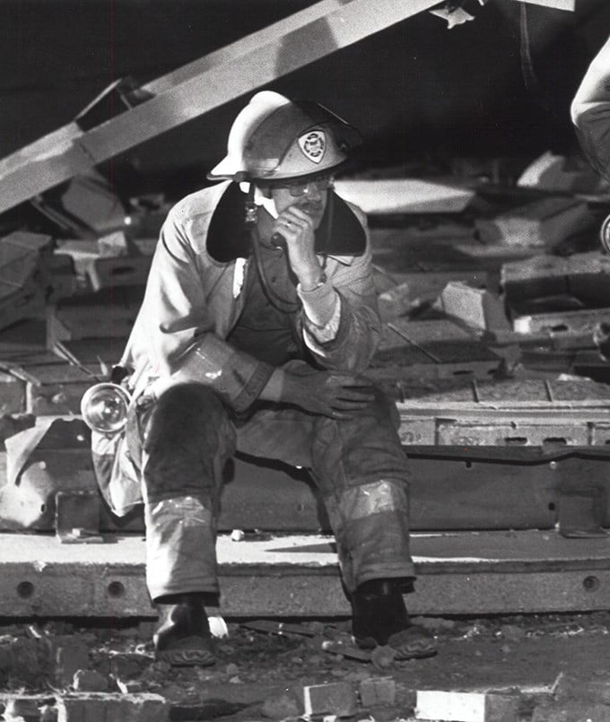 A Niles firefighter rests after the devastation