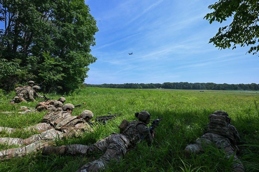 Integrated Defense Leadership Course students take a defensive position during an engagement with opposing forces at the Slagle Drop Zone at Camp James A. Garfield Joint Military Training Center